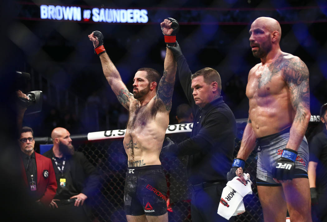 Matt Brown, left, celebrates his knockout over Ben Saunders in their welterweight bout in UFC 2 ...