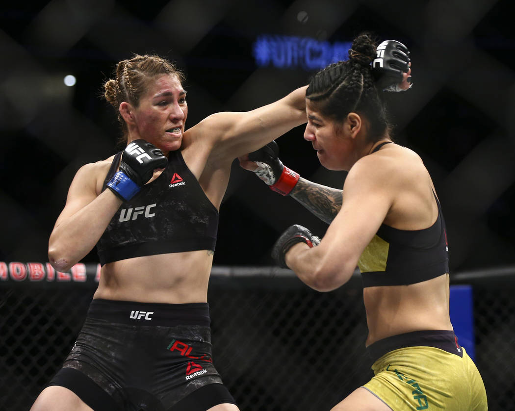 Irene Aldana, left, fights Ketlen Vieira during their bantamweight bout in UFC 245 at T-Mobile ...