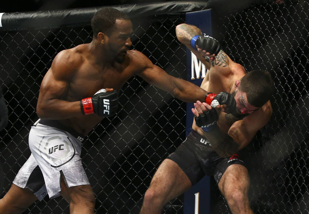 Geoff Neal, left, hits Mike Perry during their welterweight bout in UFC 245 at T-Mobile Arena i ...