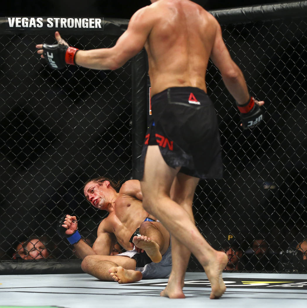 Petr Yan, right, knocks out Urijah Faber to win their bantamweight bout in UFC 245 at T-Mobile ...