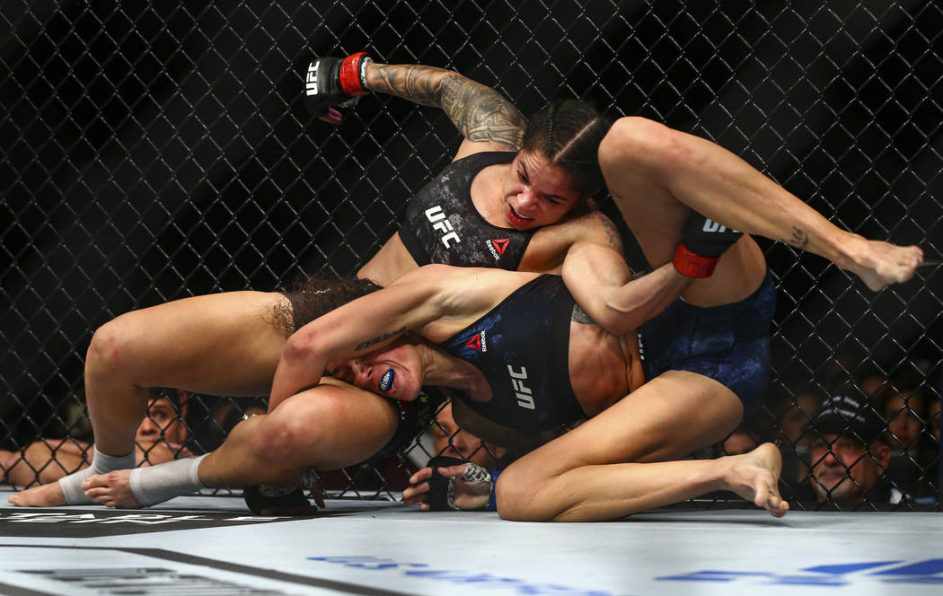 Amanda Nunes, left, fights Germaine de Randamie during their bantamweight t...