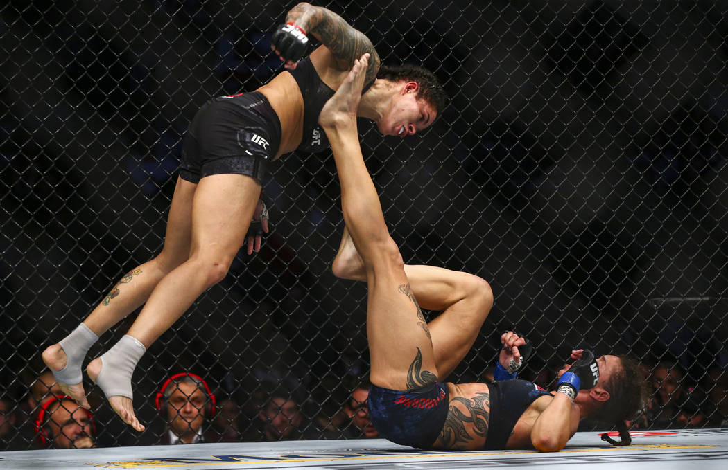 Amanda Nunes, left, fights Germaine de Randamie during their bantamweight title bout in UFC 245 ...