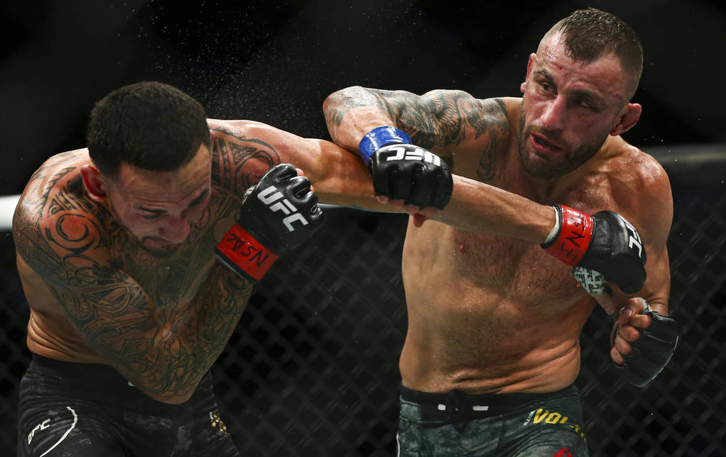 Max Holloway, left, fights Alexander Volkanovski during their featherweight title bout in UFC 2 ...