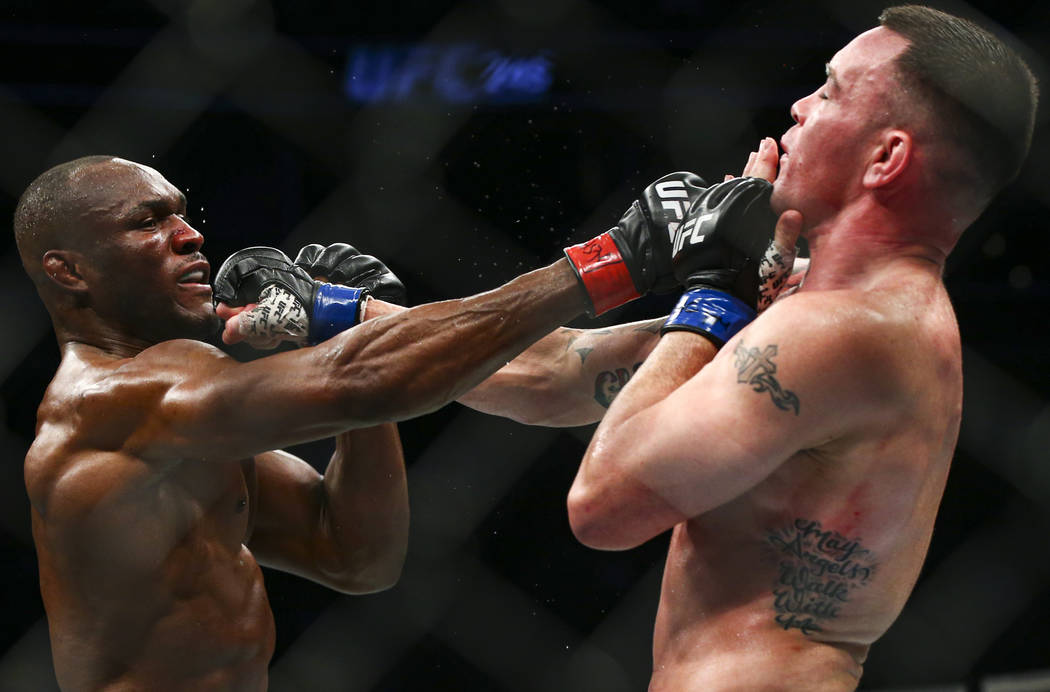 Kamaru Usman, left, fights Colby Covington during their welterweight title bout UFC 245 at T-Mo ...