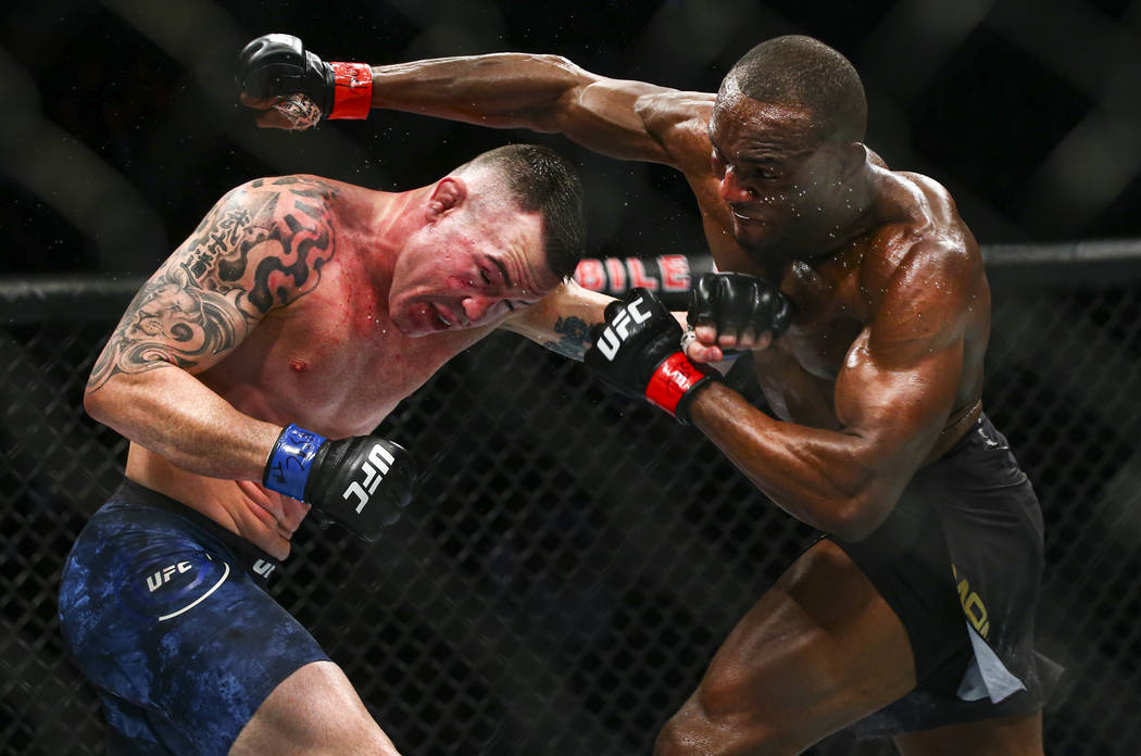 Kamaru Usman, right, fights Colby Covington during their welterweight title bout UFC 245 at T-M ...
