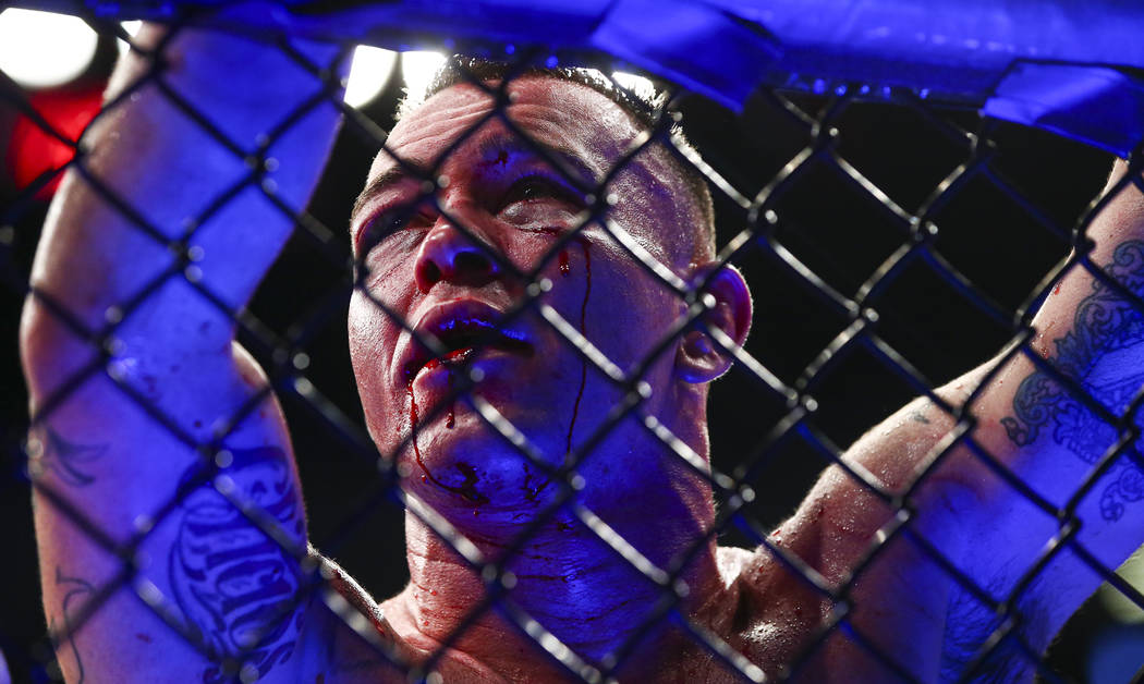 Blood drips from the face of Colby Covington after losing via technical knockout to Kamaru Usm ...