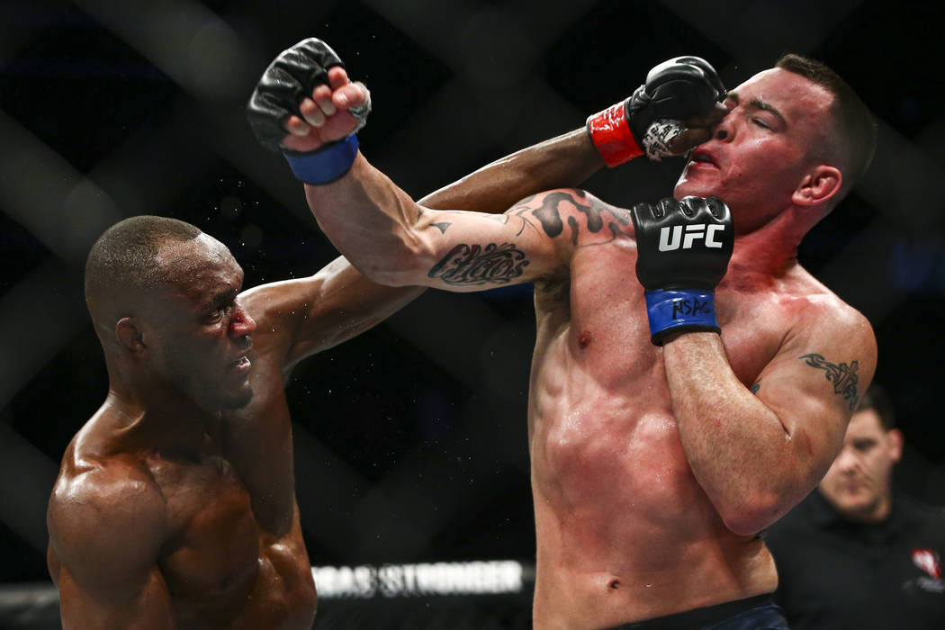 Kamaru Usman, left, fights Colby Covington during their welterweight title bout in UFC 245 at T ...