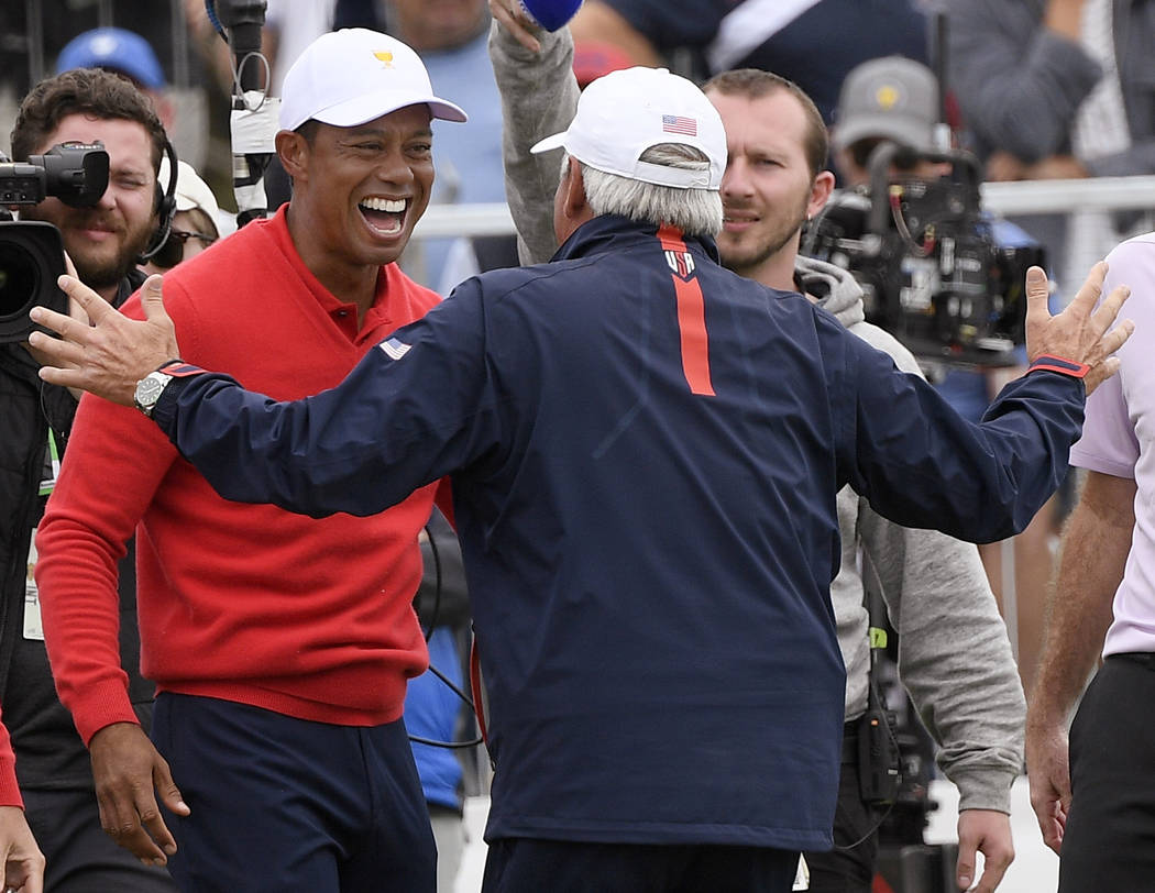 U.S. team player and captain Tiger Woods, left, celebrates with vice captain Fred Couples after ...