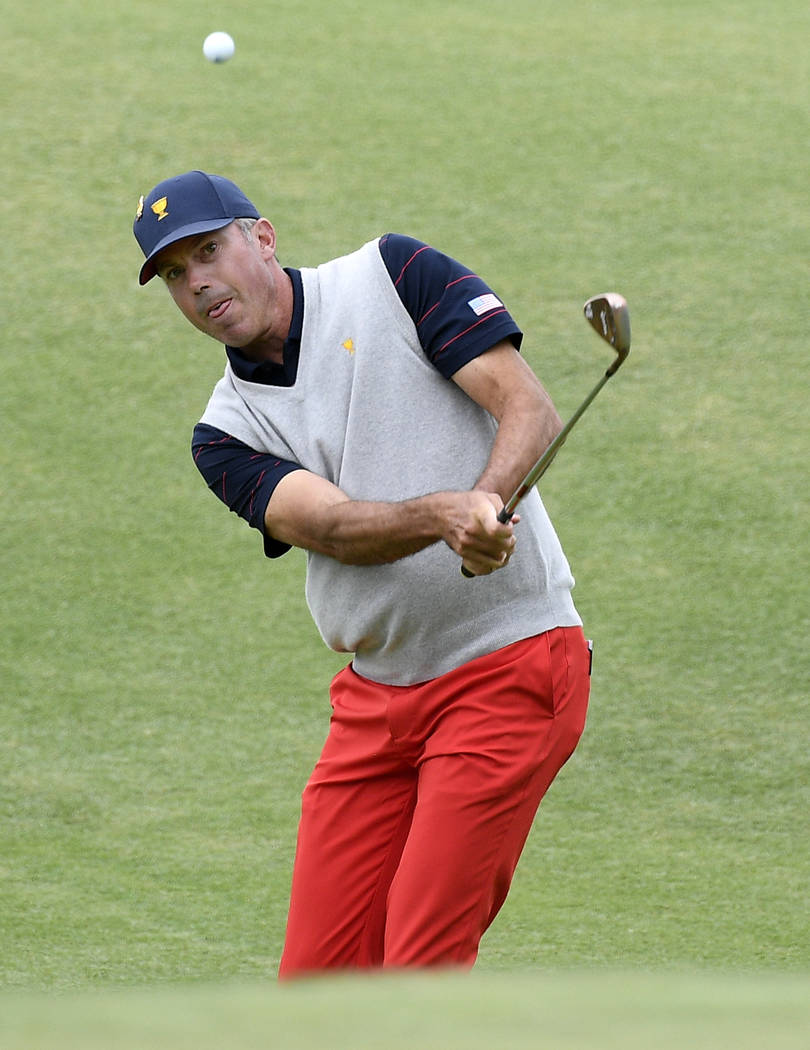 U.S. team player Matt Kuchar chips to the green on the 11th hole in their foursome match during ...
