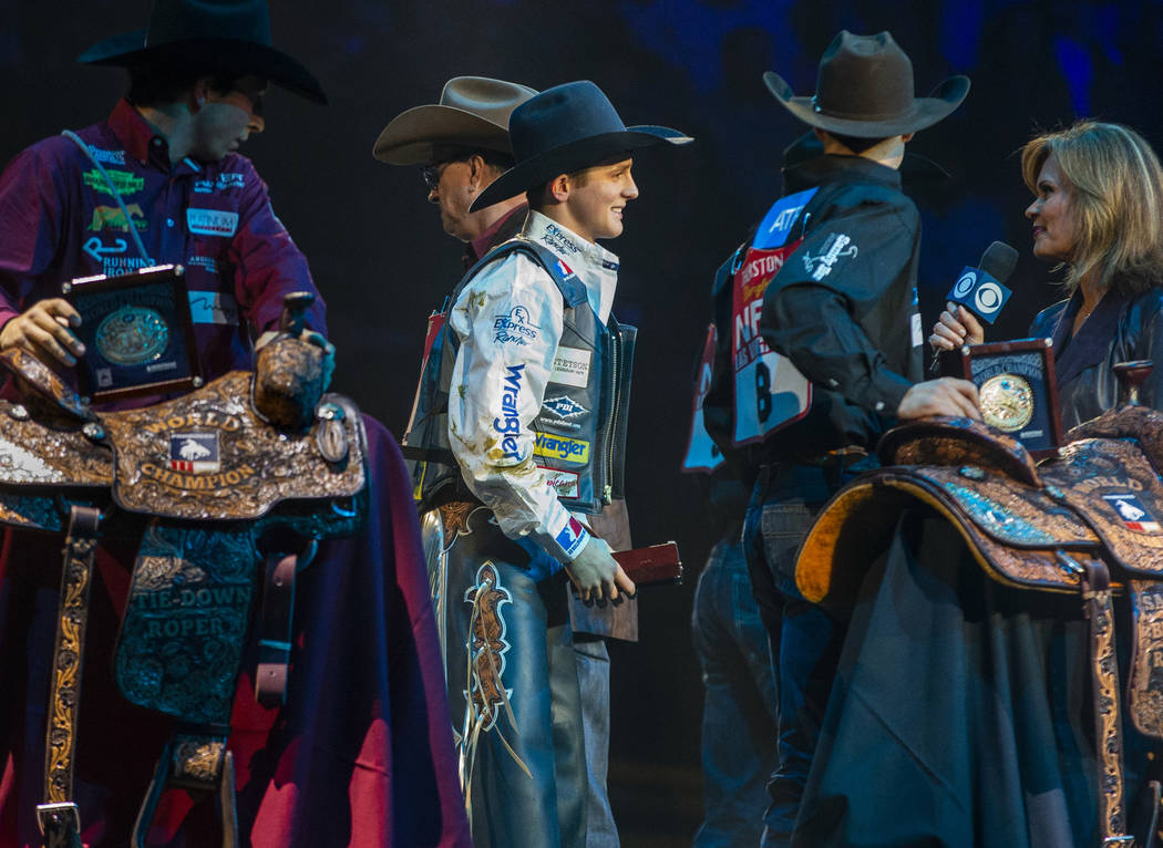 Stetson Wright of Milford, Utah, center, is named the All-Around World Champion following the t ...