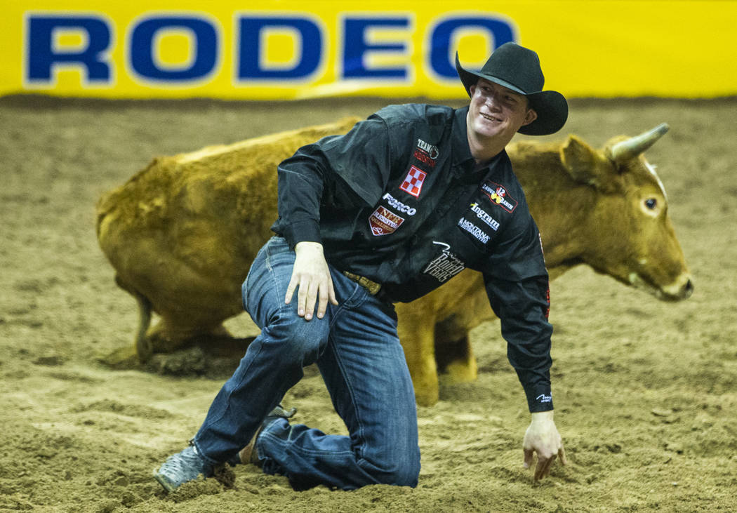 Ty Erickson of Helena, Mont., smiles after bringing down a steer in Steer Wrestling during the ...