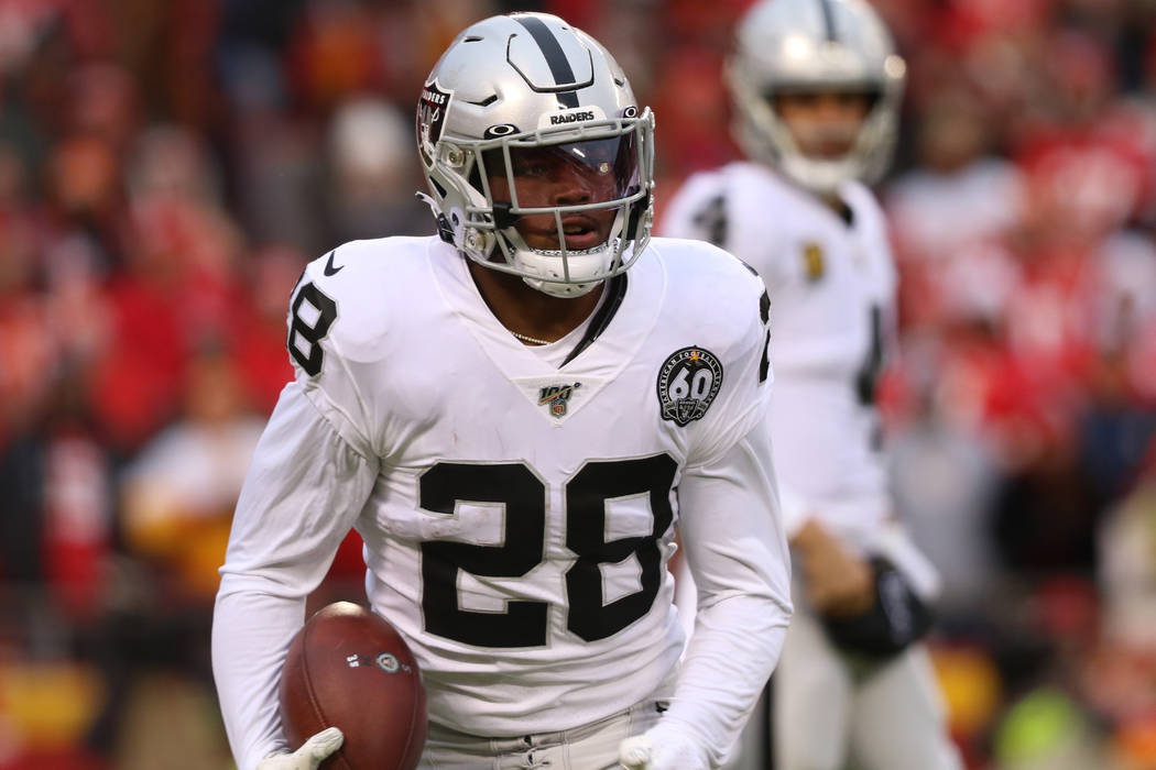 Oakland Raiders running back Josh Jacobs (28) holds on to the football after a run during the f ...