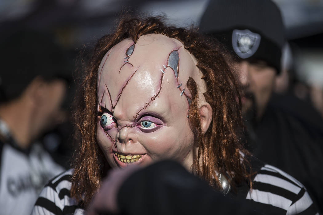 Fans tailgate outside the Oakland Coliseum before the start of an NFL football game between the ...