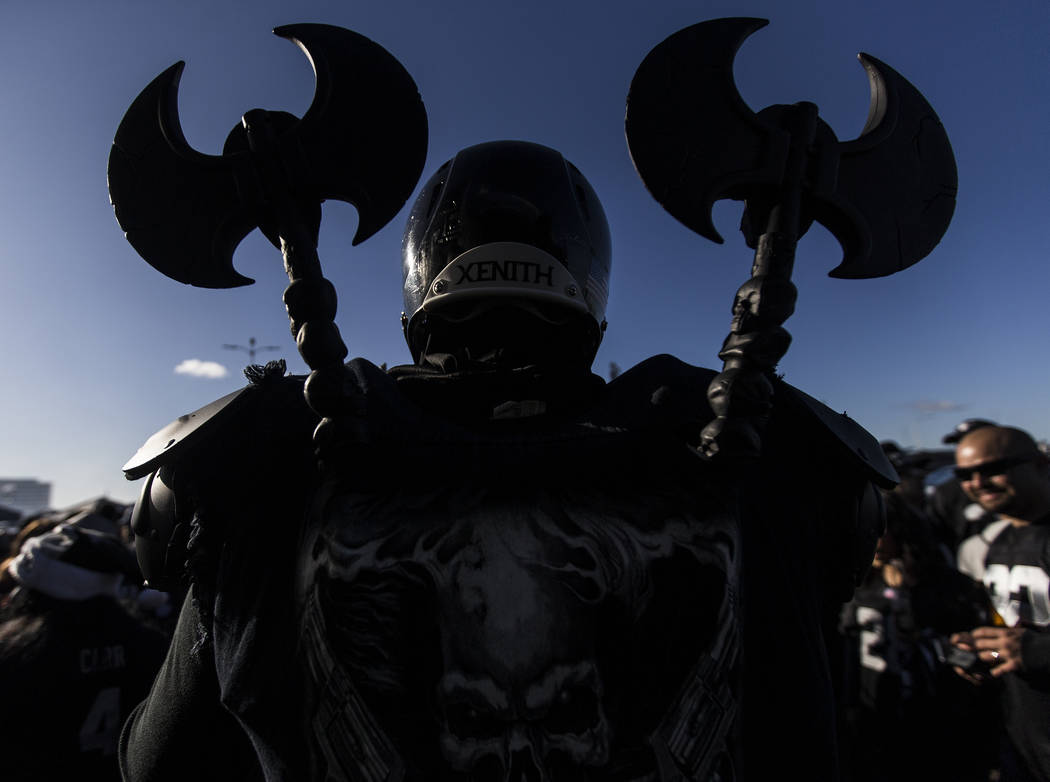 Fans tailgate outside the Oakland Coliseum before the start of an NFL football game between the ...