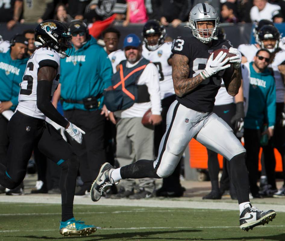 Oakland Raiders tight end Darren Waller (83) makes a big catch and run past Jacksonville Jaguar ...