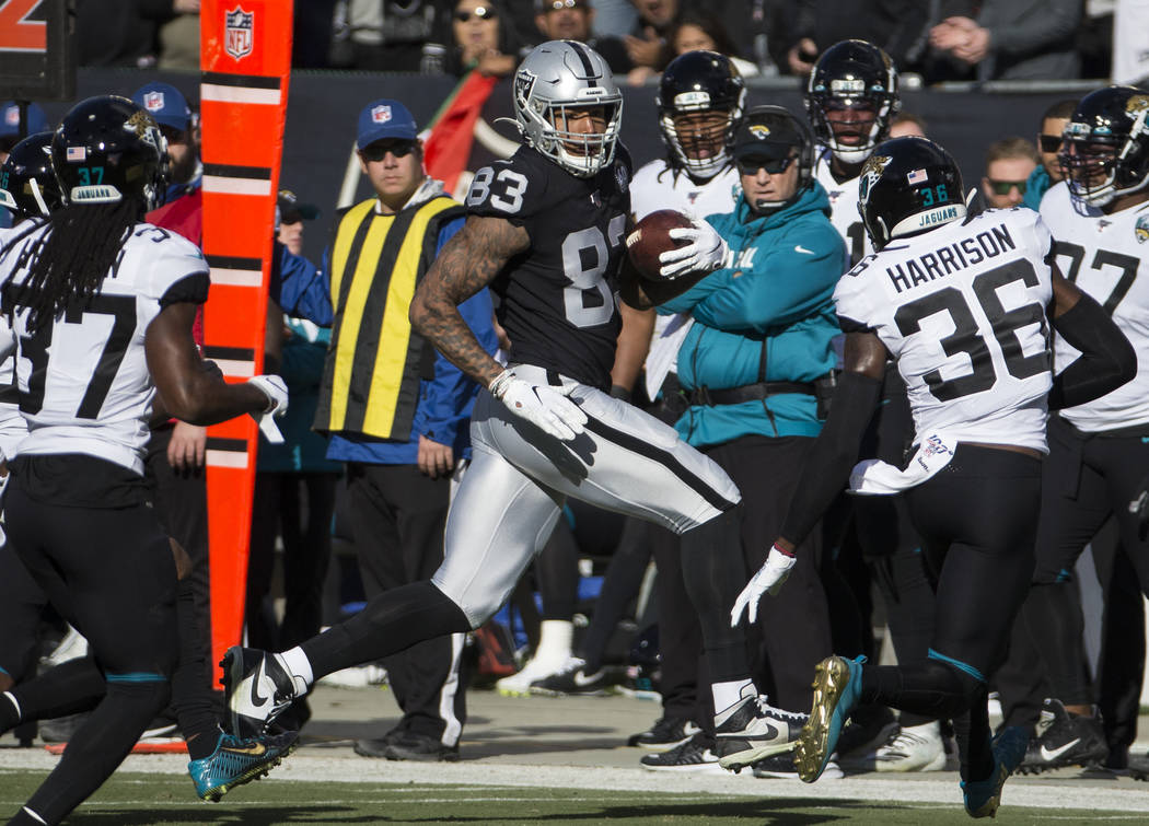 Oakland Raiders tight end Darren Waller (83) makes a big catch and run past Jacksonville Jaguar ...