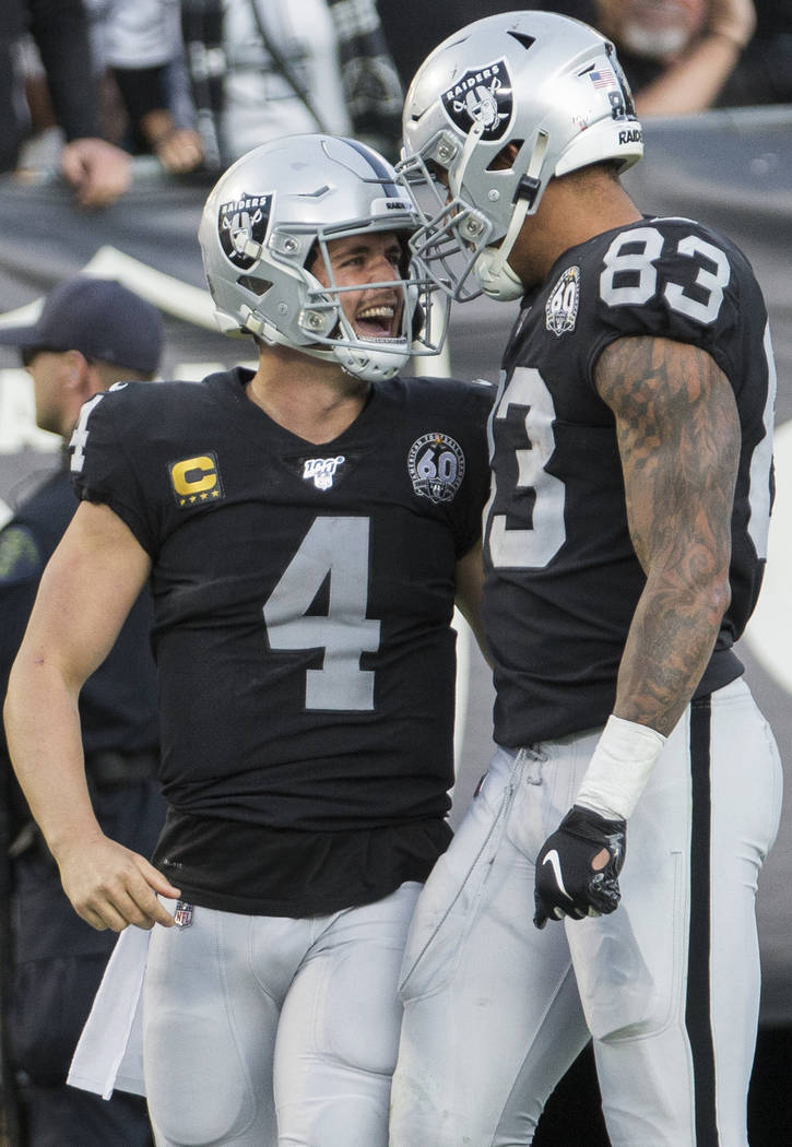 Oakland Raiders quarterback Derek Carr (4) celebrates a big run with Oakland Raiders tight end ...