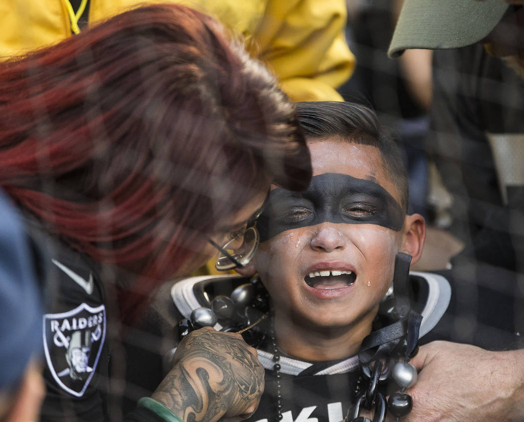 A Raider fan cries after Oakland lost to the Jacksonville Jaguars 20-16 during an NFL football ...