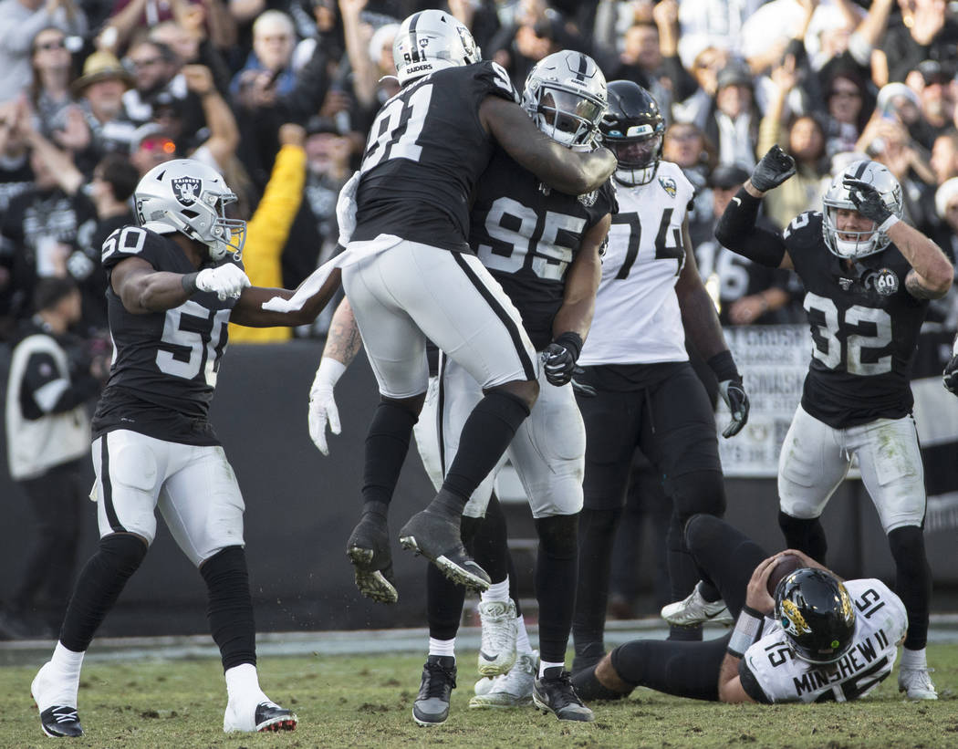 Oakland Raiders defensive end Dion Jordan (95) celebrates a defensive stop with Oakland Raiders ...
