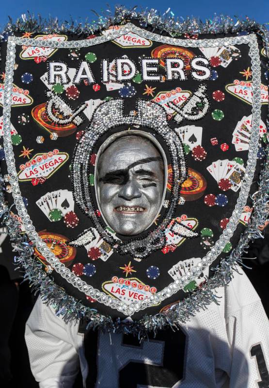 Fans tailgate outside the Oakland Coliseum before the start of an NFL football game between the ...