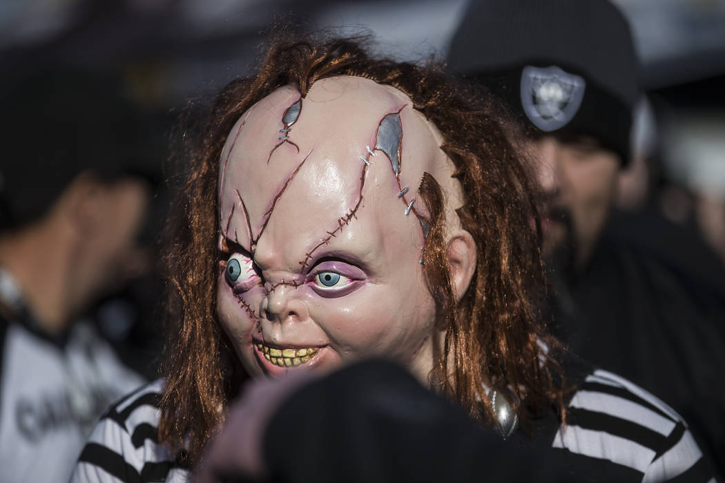 Fans tailgate outside the Oakland Coliseum before the start of an NFL football game between the ...