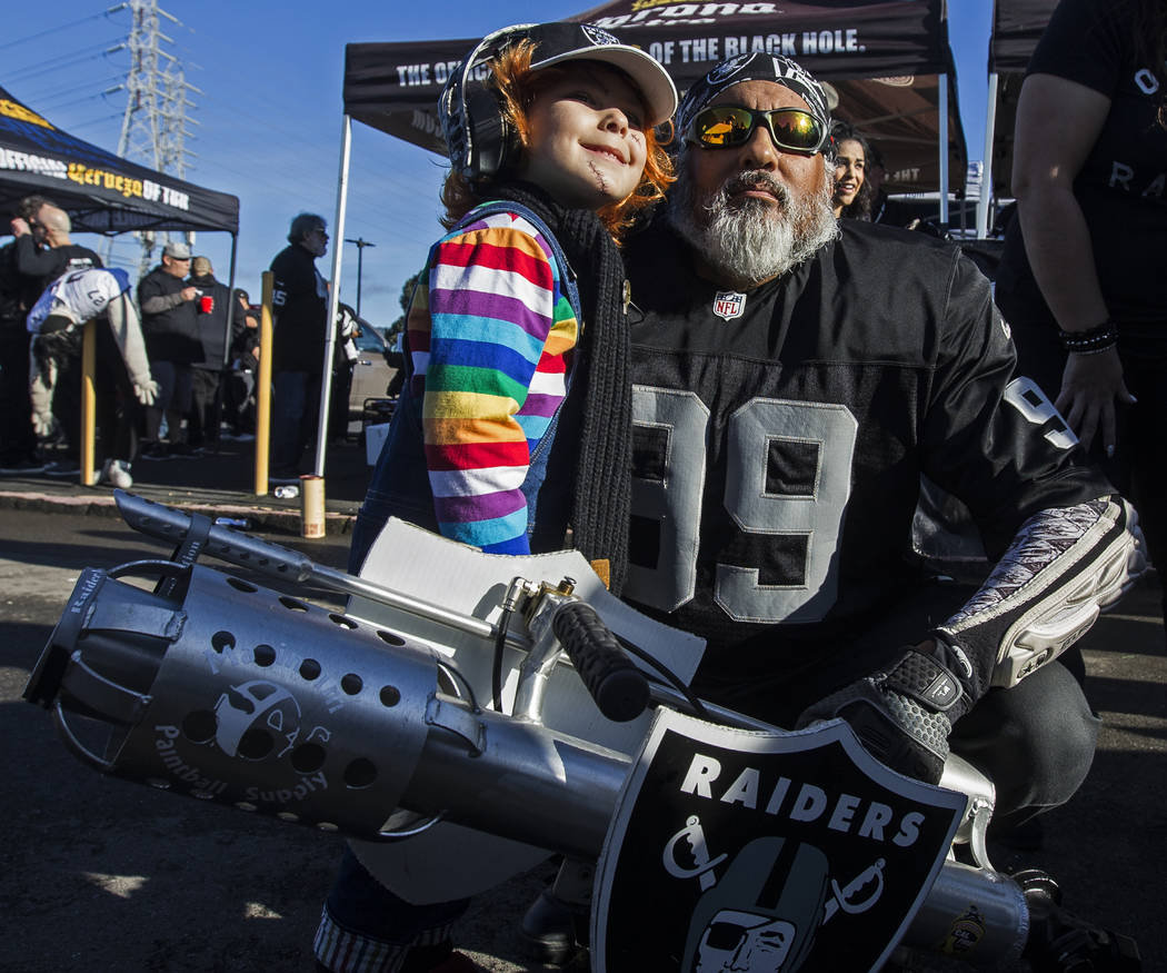 Julian Segura, left, 4, from Los Angeles, Calif., takes a photo with "The Cannon" at ...