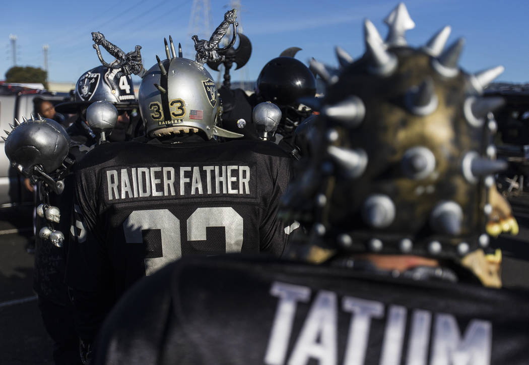 Fans tailgate outside the Oakland Coliseum before the start of an NFL football game between the ...