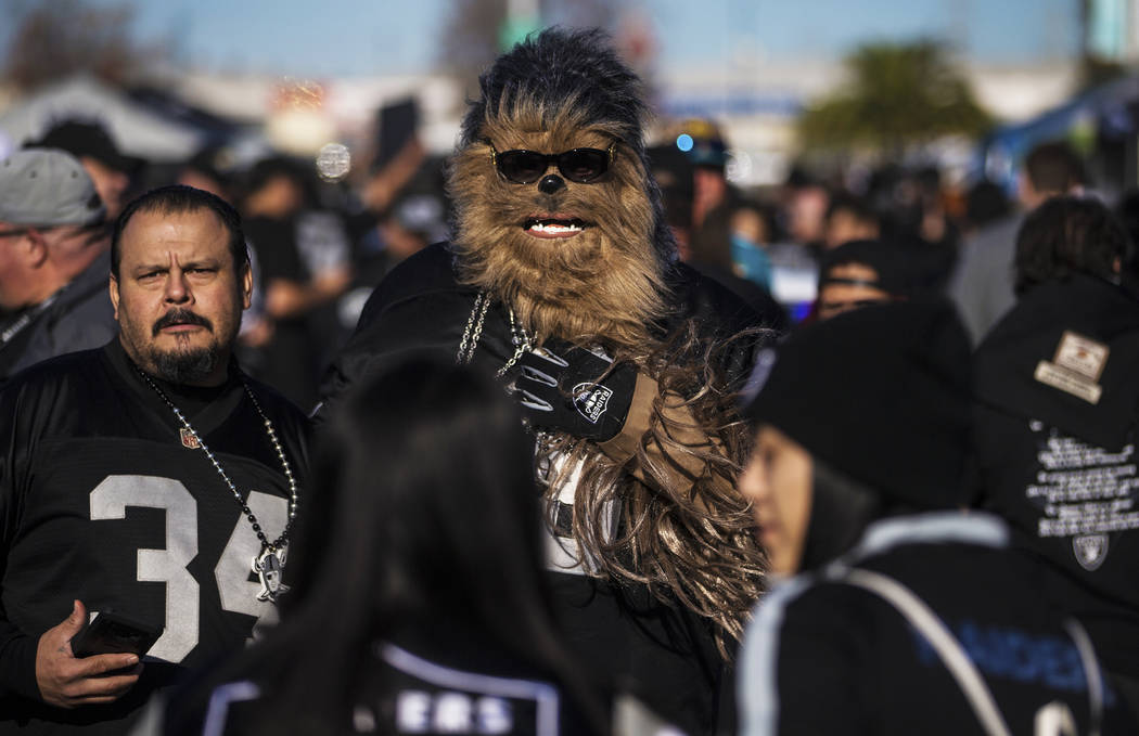 Fans tailgate outside the Oakland Coliseum before the start of an NFL football game between the ...