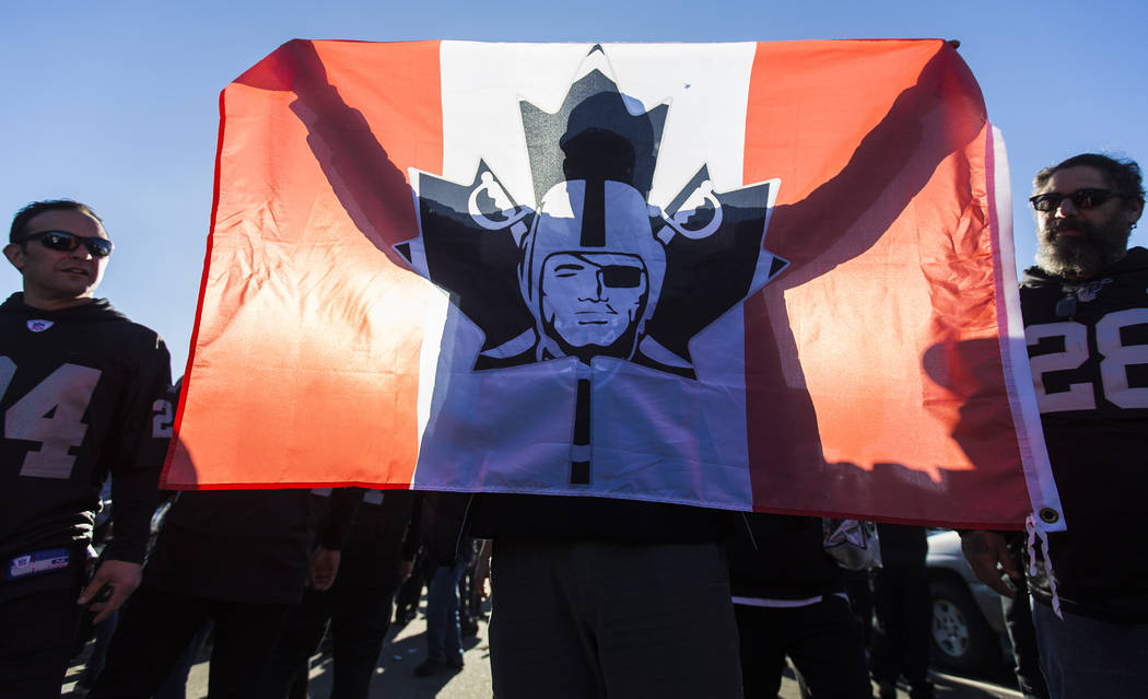 Jason Mulhall, from Toronto, Canada, tailgates outside the Oakland Coliseum before the start of ...