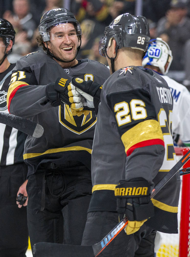 Vegas Golden Knights right wing Mark Stone (61, left) celebrates a goal with Vegas Golden Knigh ...