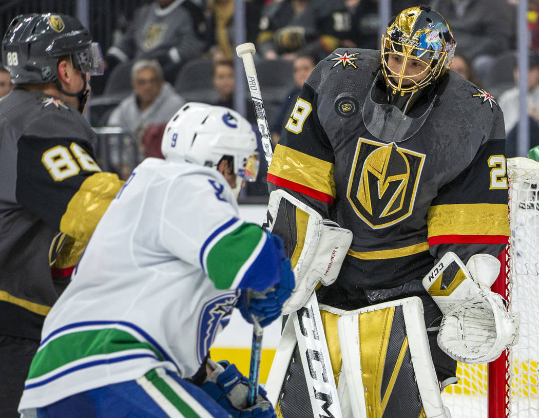 Vegas Golden Knights goaltender Marc-Andre Fleury (29, right) deflects another puck off his che ...