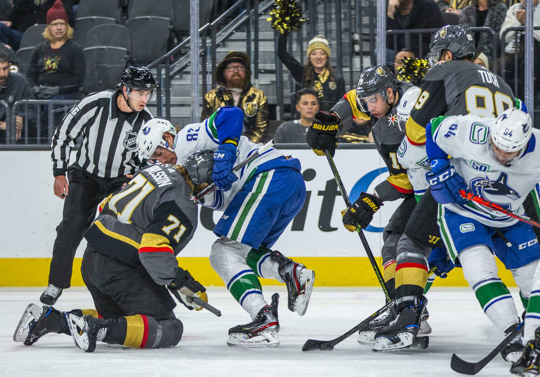 Vegas Golden Knights center William Karlsson (71, left) takes a stick under the chin from Vanco ...