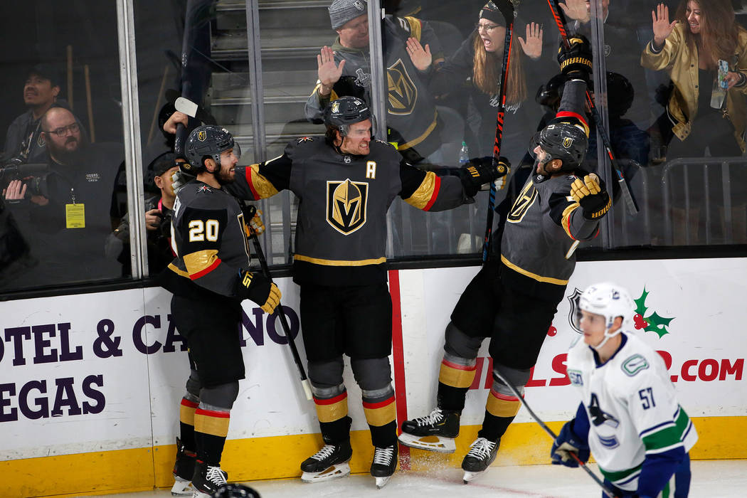 Vegas Golden Knights right wing Mark Stone (61) celebrates with his teammates center Chandler S ...