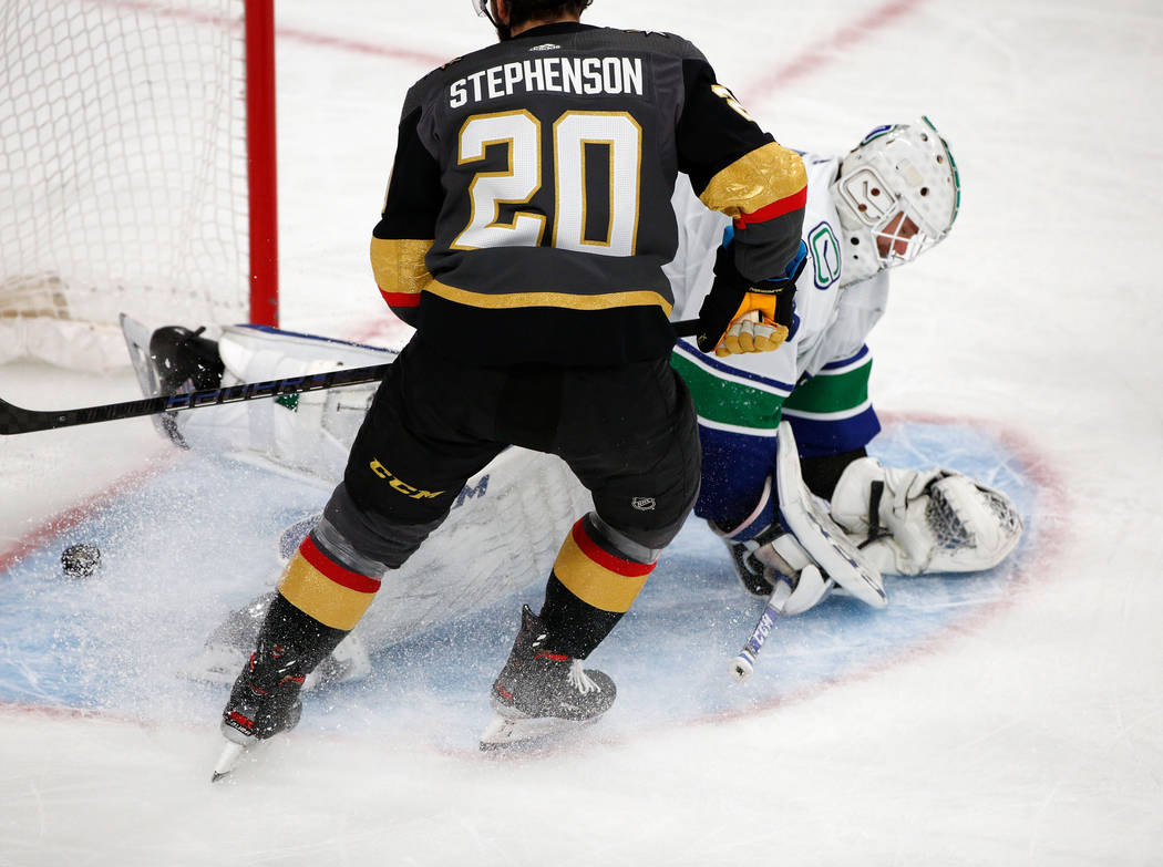 Vancouver Canucks goaltender Jacob Markstrom (25), right, cannot stop a puck shot by Vegas Gold ...