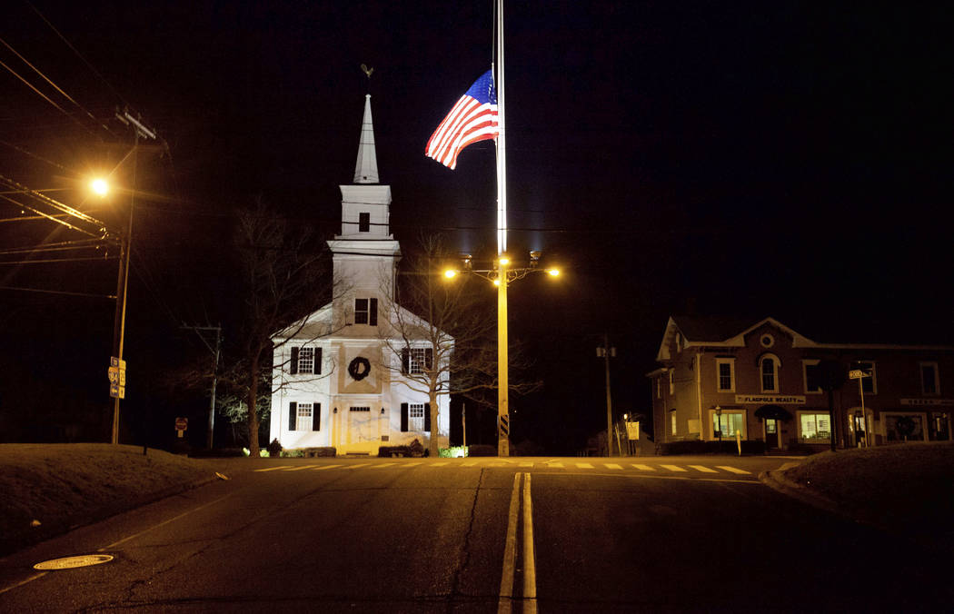 FILE - In this Dec. 15, 2012 file photo, a U.S. flag flies at half-staff on Main Street in Newt ...
