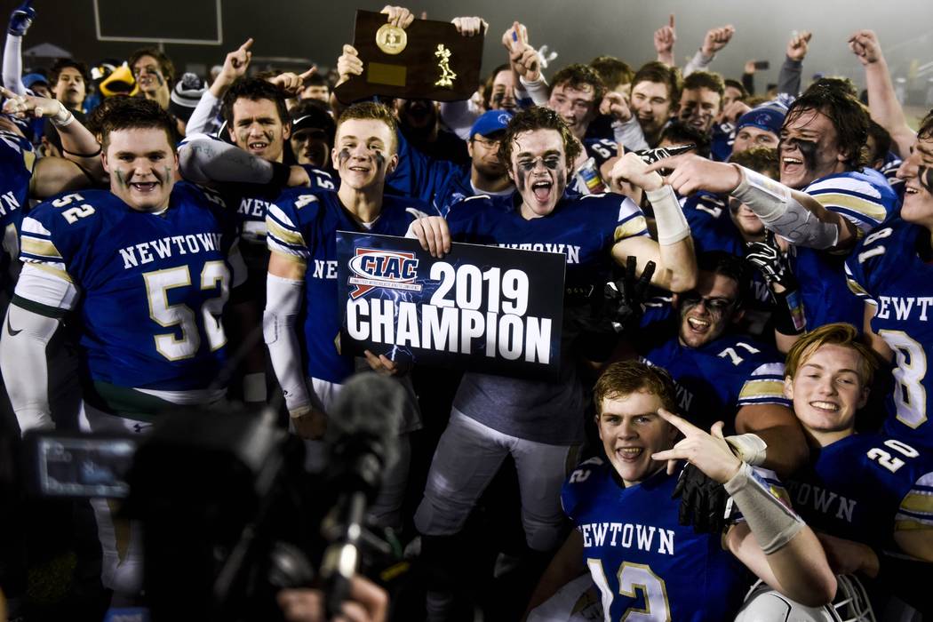 Newtown Nighthawks celebrate their win after beating the Darien Blue Wave in the final play of ...
