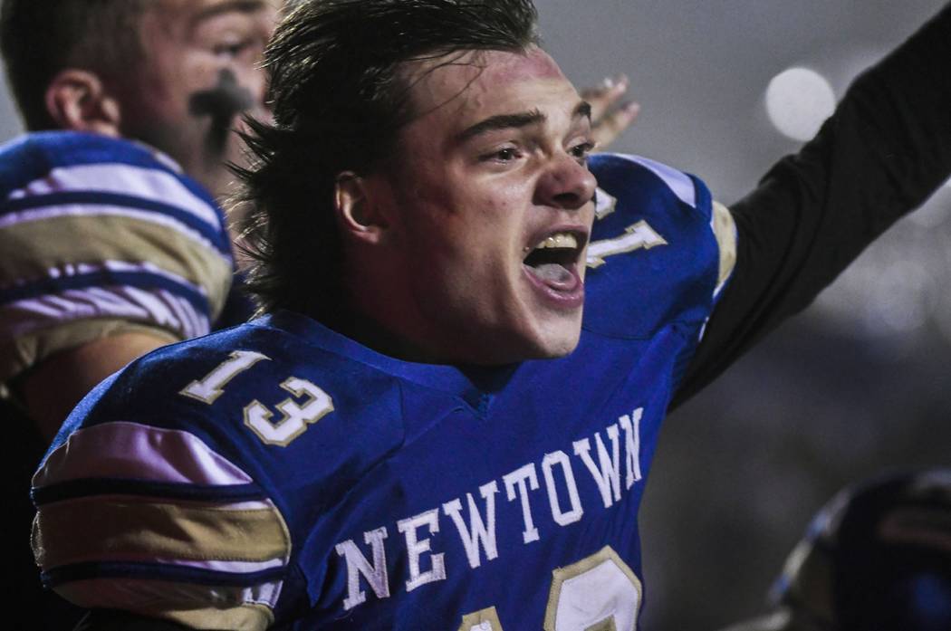 Newtown's Riley Ward (13) reacts and looks back at his teammates after scoring the winning touc ...