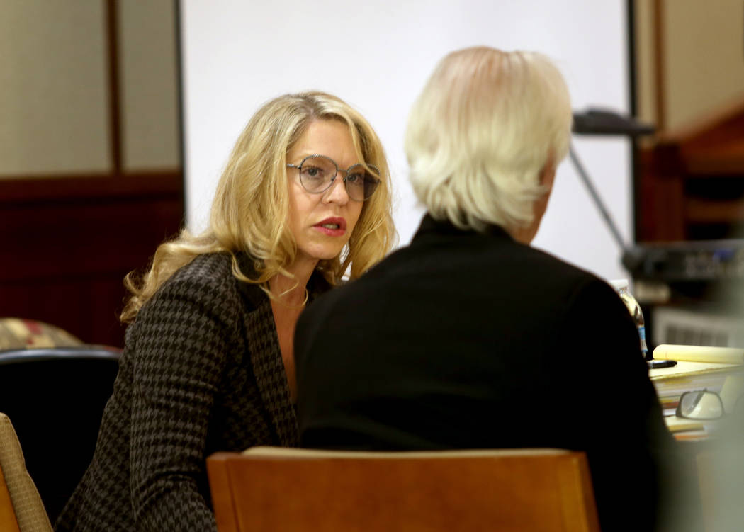 Las Vegas Justice of the Peace Melanie Andress-Tobiasson speaks with her attorney, Bill Terry, ...