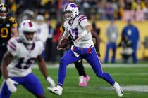 Buffalo Bills quarterback Josh Allen (17) scrambles during the first half of an NFL football ga ...
