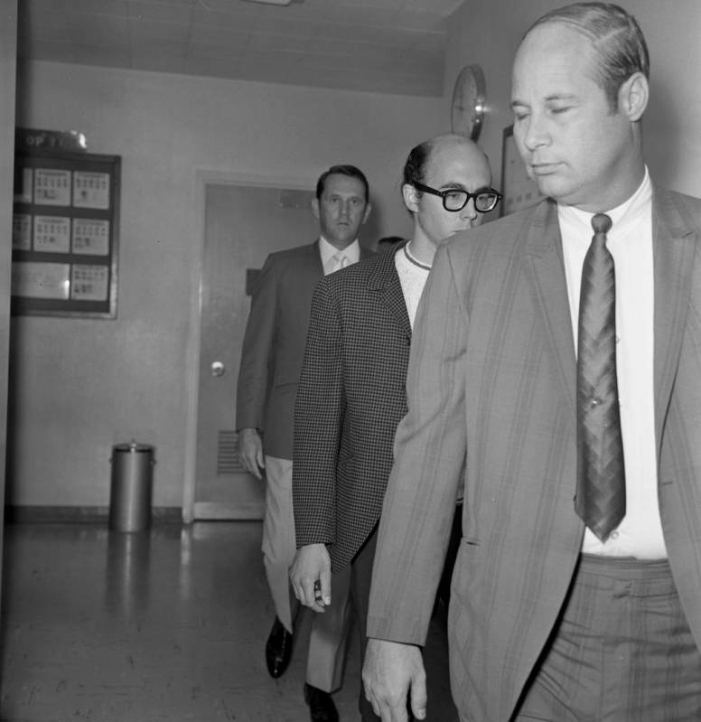 Russell Payne, 25, is taken through a corridor at Clark County Courthouse after surrendering in ...
