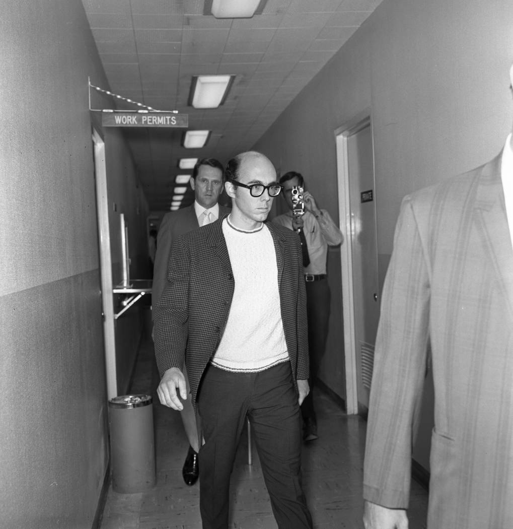 Russell Payne, 25, is taken through a corridor at Clark County Courthouse after surrendering in ...