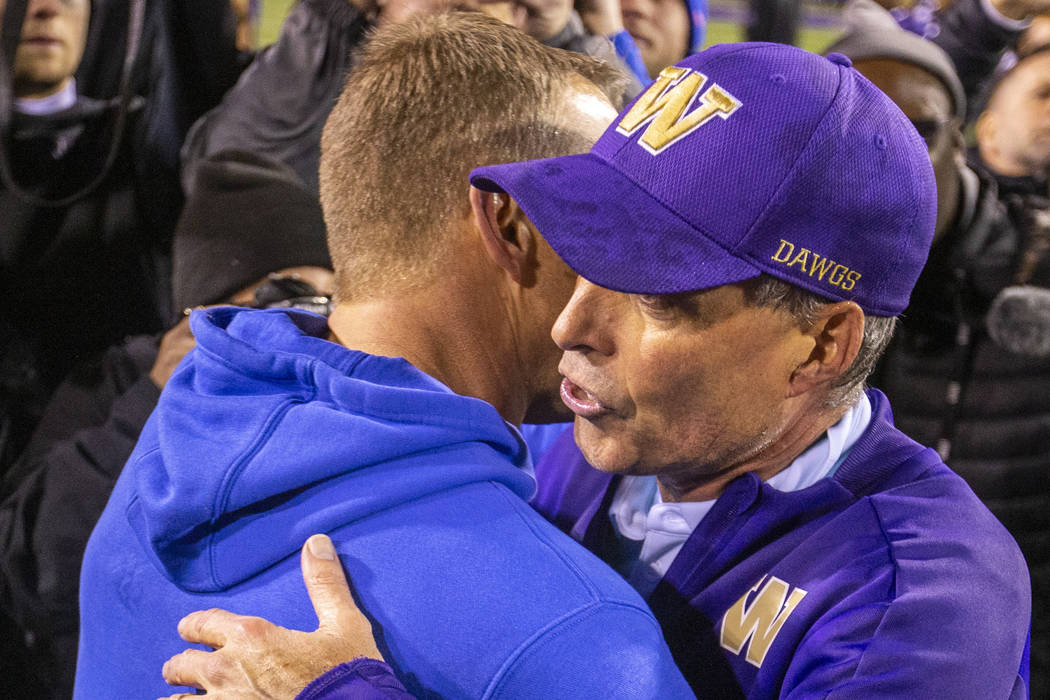 Boise State Broncos head coach Bryan Harsin, left, embraces Washington Huskies head coach Chris ...