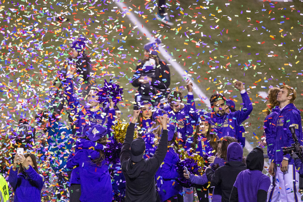 Confetti rains down on Washington Huskies cheerleaders while the trophy is presented after defe ...