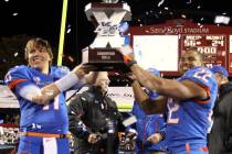 Boise State quarterback Kellen Moore, left, and running back Doug Martin hoist the trophy after ...
