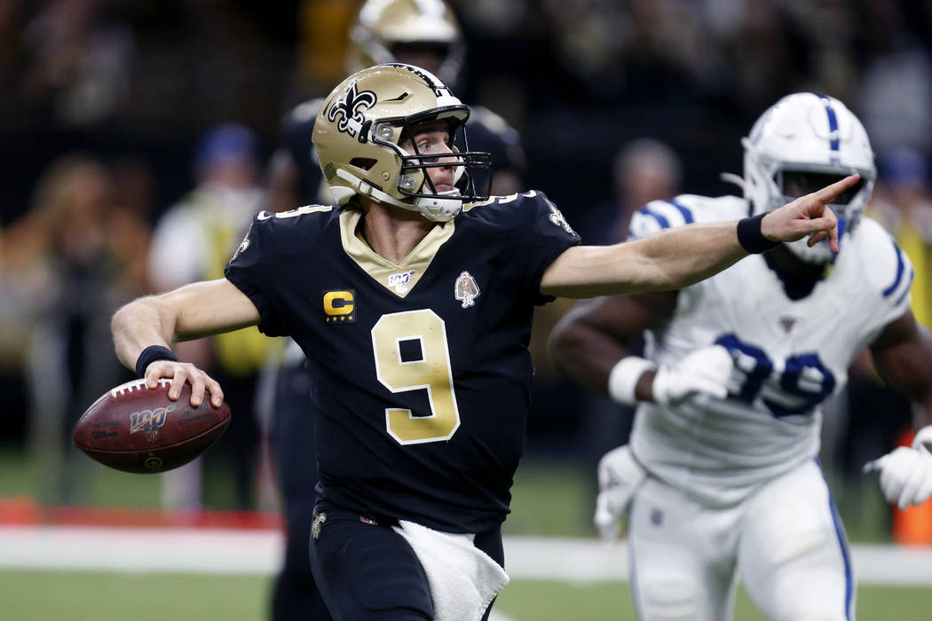 New Orleans Saints quarterback Drew Brees (9) scrambles to pass in the first half of an NFL foo ...
