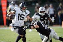 Jacksonville Jaguars quarterback Gardner Minshew runs with the ball away from Oakland Raiders i ...