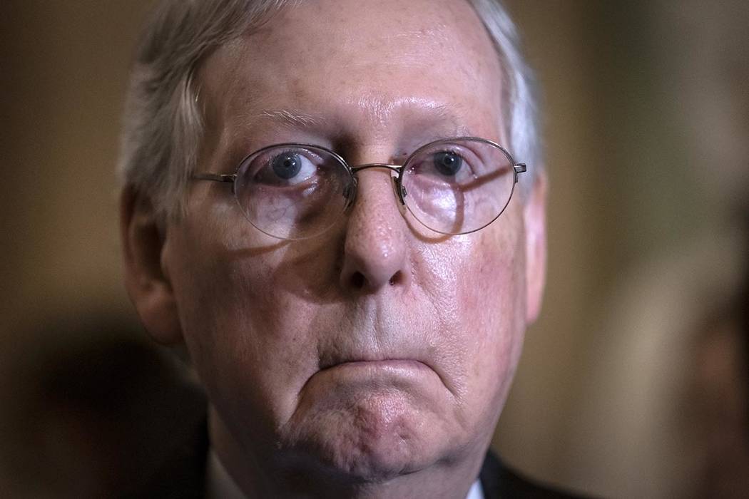 Senate Majority Leader Mitch McConnell, R-Ky., fields questions from reporters about an impeach ...