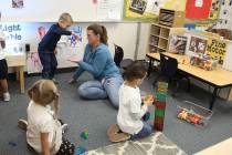 Specialized Programs Teaching Assistant, Heather Atkin, plays with pre-kindergarten students, i ...