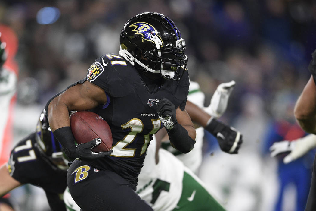 Baltimore Ravens running back Mark Ingram (21) runs with the ball during the first half of an N ...