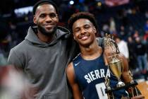 LeBron James, left, poses with his son Bronny after Sierra Canyon beat Akron St. Vincent-St. Ma ...